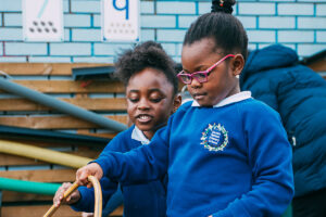 Two Children Using Hosepipe