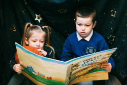 Two Children Reading Big Book