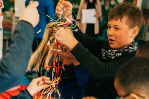 Child Holding Wires