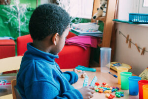 Boy playing with colourful pieces